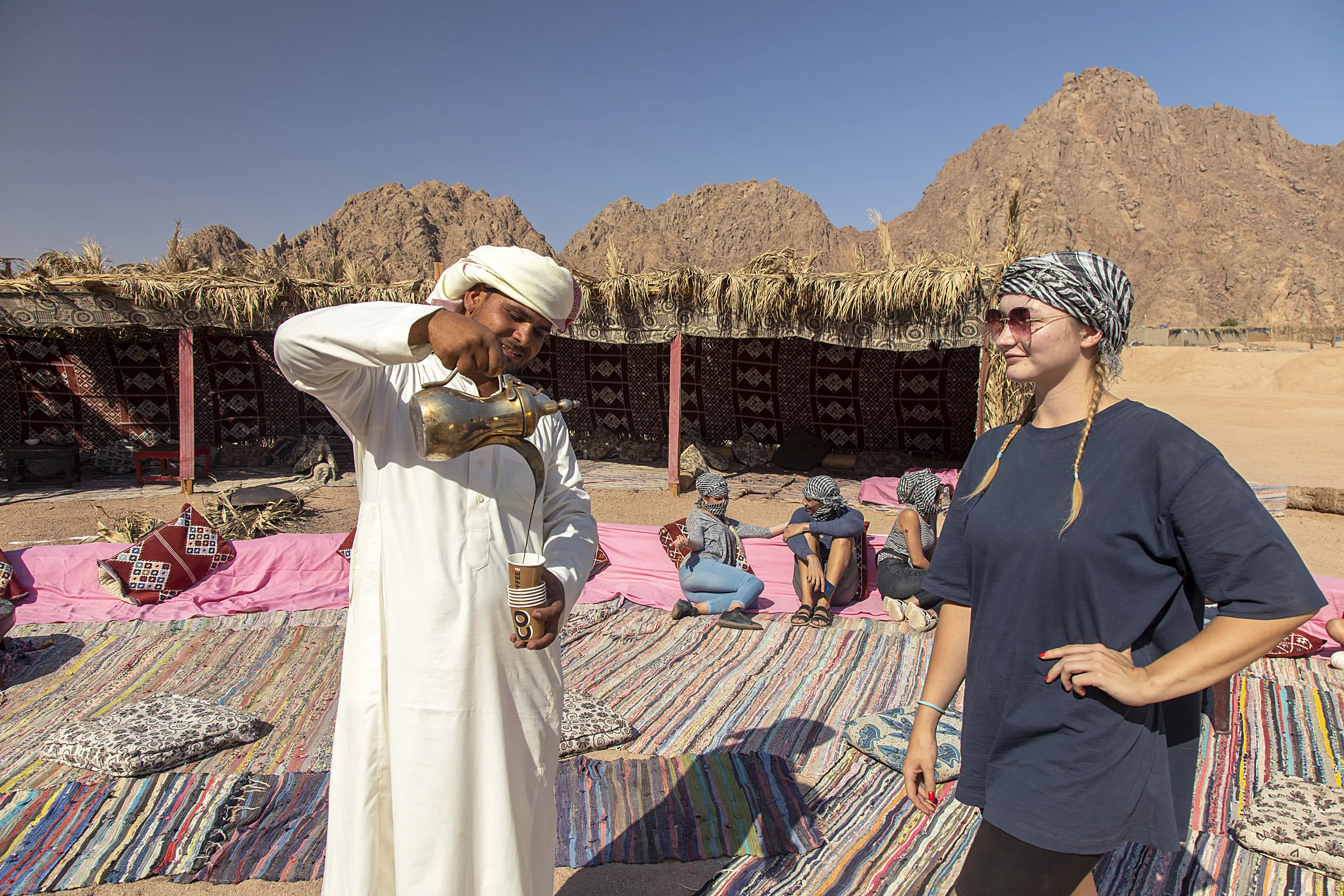 camel riding in desert