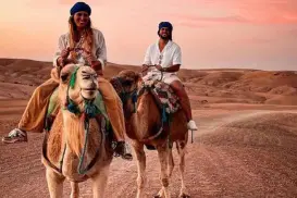 camel riding in desert